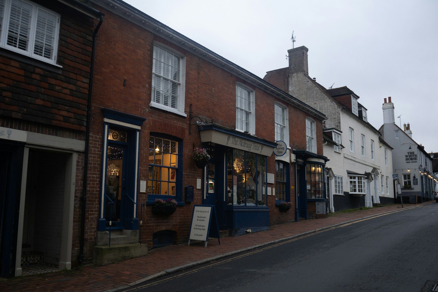 A row of independent storefronts along a neighborhood street.
